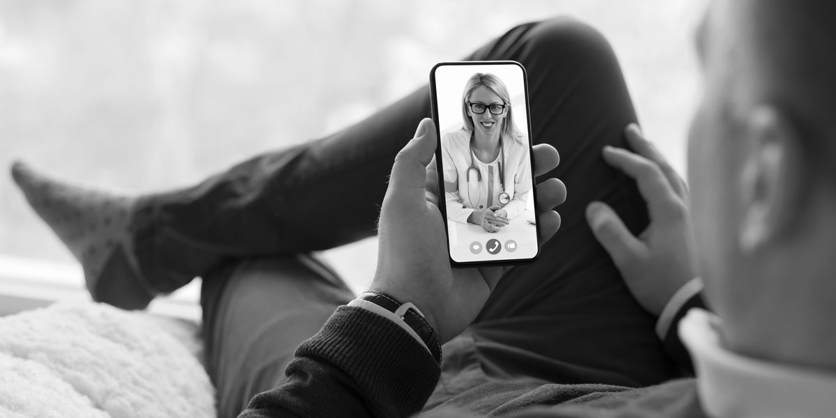 man using his phone for telehealth