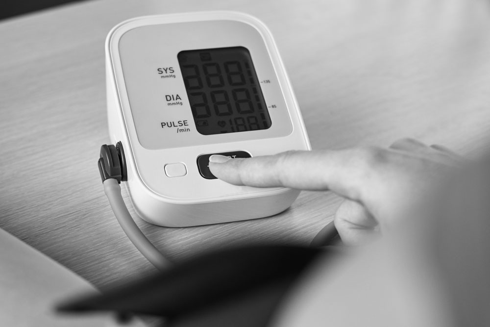 person using a blood pressure machine