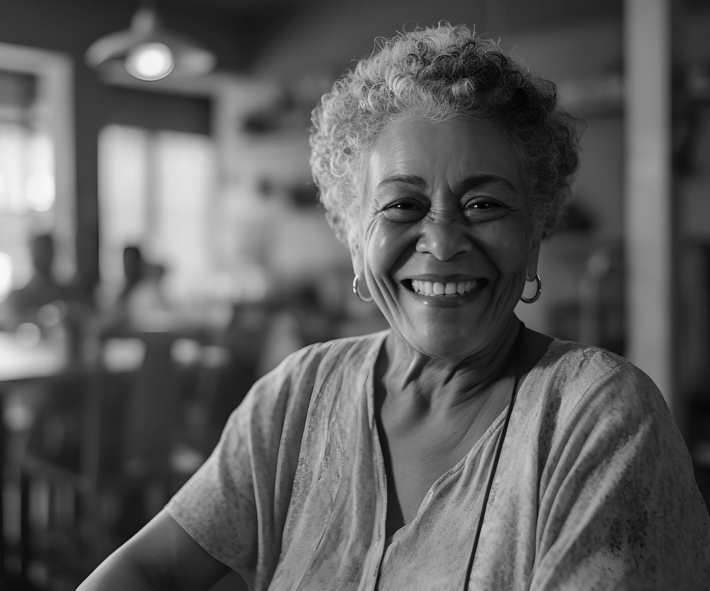 older woman looking at the camera in a cafe